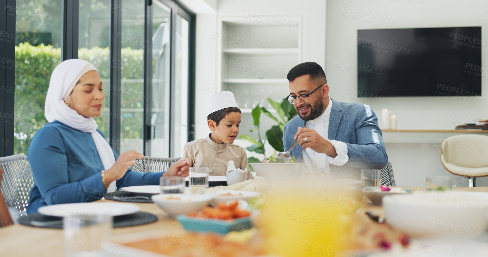 Buy stock photo Islamic, family and dinner at dining table for ramadan, muslim celebration and eating food at home. Eid mubarak, culture and religious gathering with mother, father and son for bonding in apartment