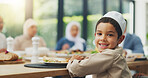 Children, eid and portrait of muslim boy eating food with family in dining room of home for celebration. Dinner, happy or smile with face of Islamic child in apartment for culture, event or tradition