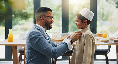 Buy stock photo Muslim, dad and dressing of boy in home, celebration and holiday of Eid al Fitr, religion and clothes for culture. House, man and son in dining room, ready and happy for Ramadan, festive and feast