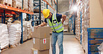 Back pain, man and boxes in warehouse for injury, overworked and strain with inventory. Logistics, male worker and backache in factory for export, commerce and packaging for trade or shipping