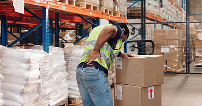 Buy stock photo Pallet truck, man and back pain in warehouse with transport, safety and storage for distribution or delivery. Freight operator, logistics and stock in cardboard for shipping, cargo and inventory