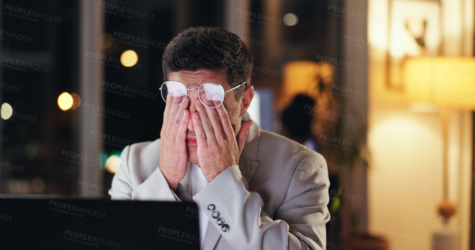 Buy stock photo Businessman, headache and night with laptop in stress, debt or bankruptcy from burnout at office. Frustrated or tired man working late with strain in depression, financial crisis or loss from mistake