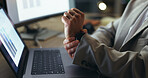 Person, hands and night with laptop for wrist pain, injury or arthritis at office desk. Closeup of employee working late with sore muscle, joint ache or carpal tunnel syndrome for strain at workplace