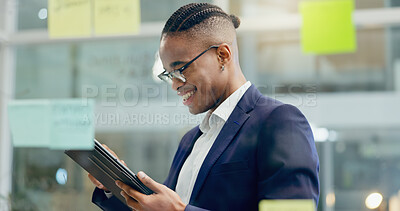 Buy stock photo Tablet, research and businessman in office by glass wall for planning, brainstorming or ideas. Smile, reading and African male financial advisor with digital technology for company budget project.