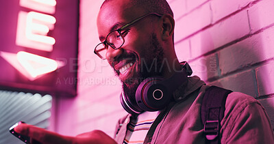 Buy stock photo Cellphone, texting and black man with smile, headphones and communication with contact and online. Student, social media and chat on app, typing and happy in campus, college and Gen z with connection