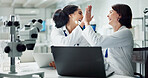 Happy woman, scientist and high five with colleague for teamwork, breakthrough or new discovery on laptop at lab. Female person or medical professionals touching with smile for success at laboratory