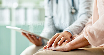 Buy stock photo Doctor, patient and holding hands with tablet at hospital with support, empathy and consultation. Medic, person and digital touchscreen with comfort, diagnosis or app for healthcare service at clinic