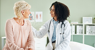 Buy stock photo Senior woman, doctor and comfort in consultation with discussion, smile and good news at wellness clinic. Medic, people and happy with support, counselling and review for health on bed at hospital