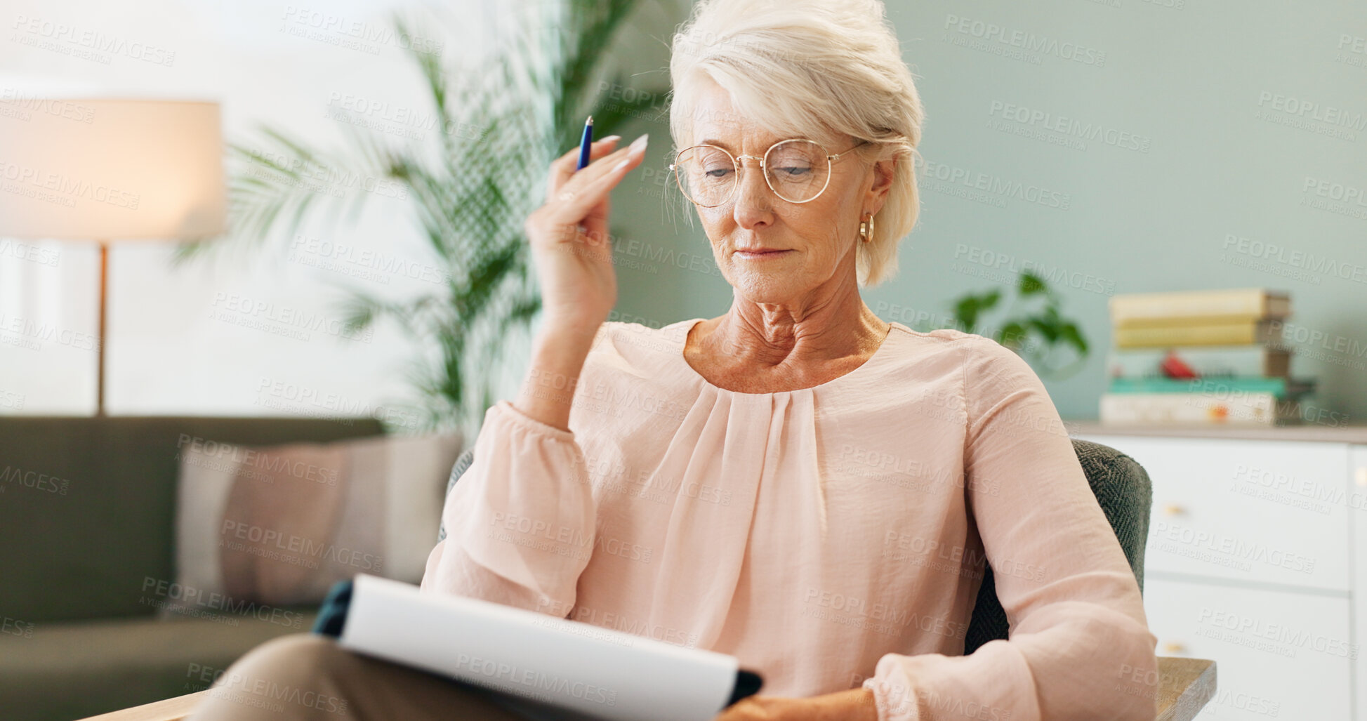 Buy stock photo Mature woman, notes and home office with reading, therapy sofa and freelance employee with document. Living room, working and notebook with planning, writing and remote job in a lounge with glasses