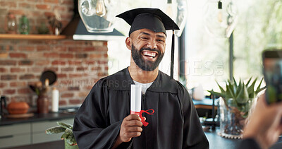 Buy stock photo Graduation, man and happy with photo in home with certificate, diploma and success in education. Student, picture and laughing for social media post, memory and celebration for study achievement