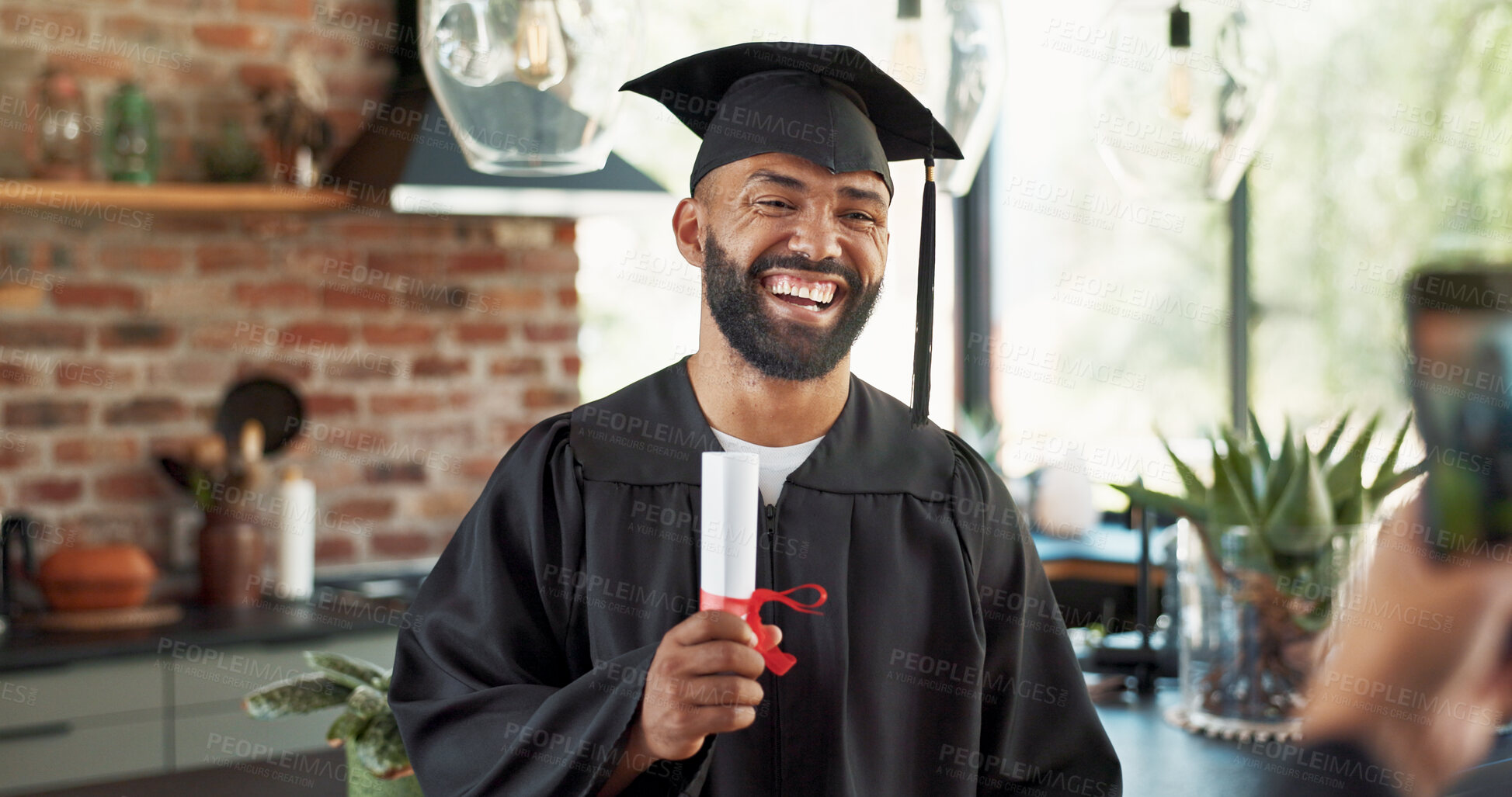 Buy stock photo Graduation, man and happy with photo in home with certificate, diploma and success in education. Student, picture and laughing for social media post, memory and celebration for study achievement