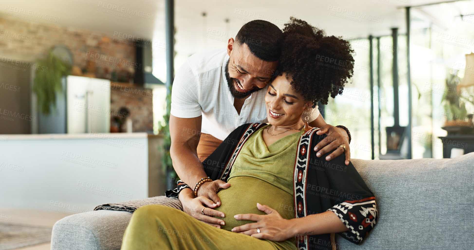 Buy stock photo Pregnant, couple and woman on couch with bonding, tummy touch and support with maternity and motherhood. Future parents, affection on sofa and healthy pregnancy with embrace and excited for baby