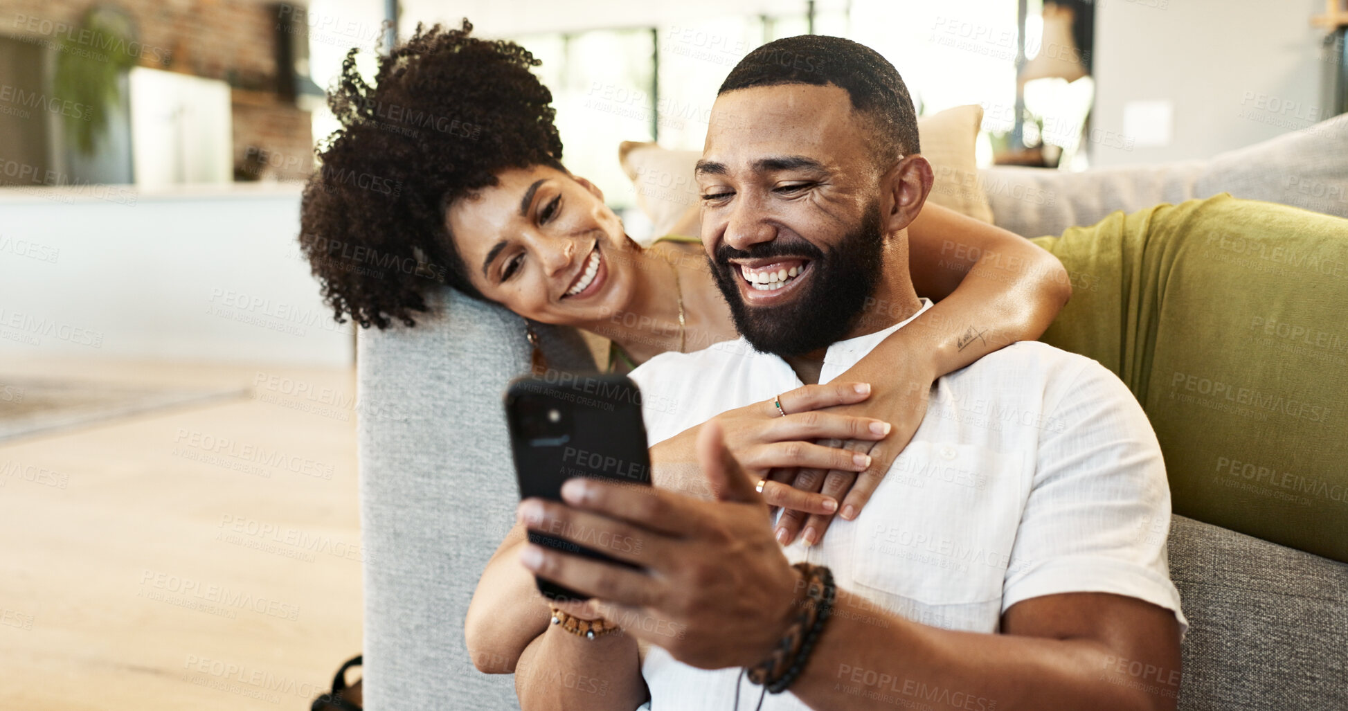 Buy stock photo Couple, hug and laughing for phone in house with social media meme, internet joke and comic notification. People, happy and smartphone in living room with funny web search, bonding or embrace in home