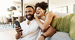 Couple, phone and couch with social media, laughing and smile together in home with app. Online shopping, relax and happy people with technology and funny video with meme and joke on the internet