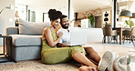 Laptop, relax and couple on floor in home for bonding, loving relationship and happy together. Marriage, living room and man and woman on computer for internet videos, website and online streaming