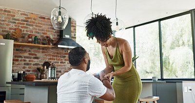 Buy stock photo Couple, proposal and excited with engagement in home for commitment, marriage promise and ring box on knee. People, question or romantic gesture in kitchen of house with love, future together and yes