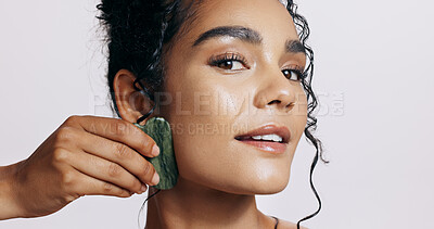 Buy stock photo Skincare, portrait and woman with gua sha for wellness, dermatology and luxury spa. Face, cosmetics and lady glow with jade crystal, anti aging or natural stone treatment on white studio background