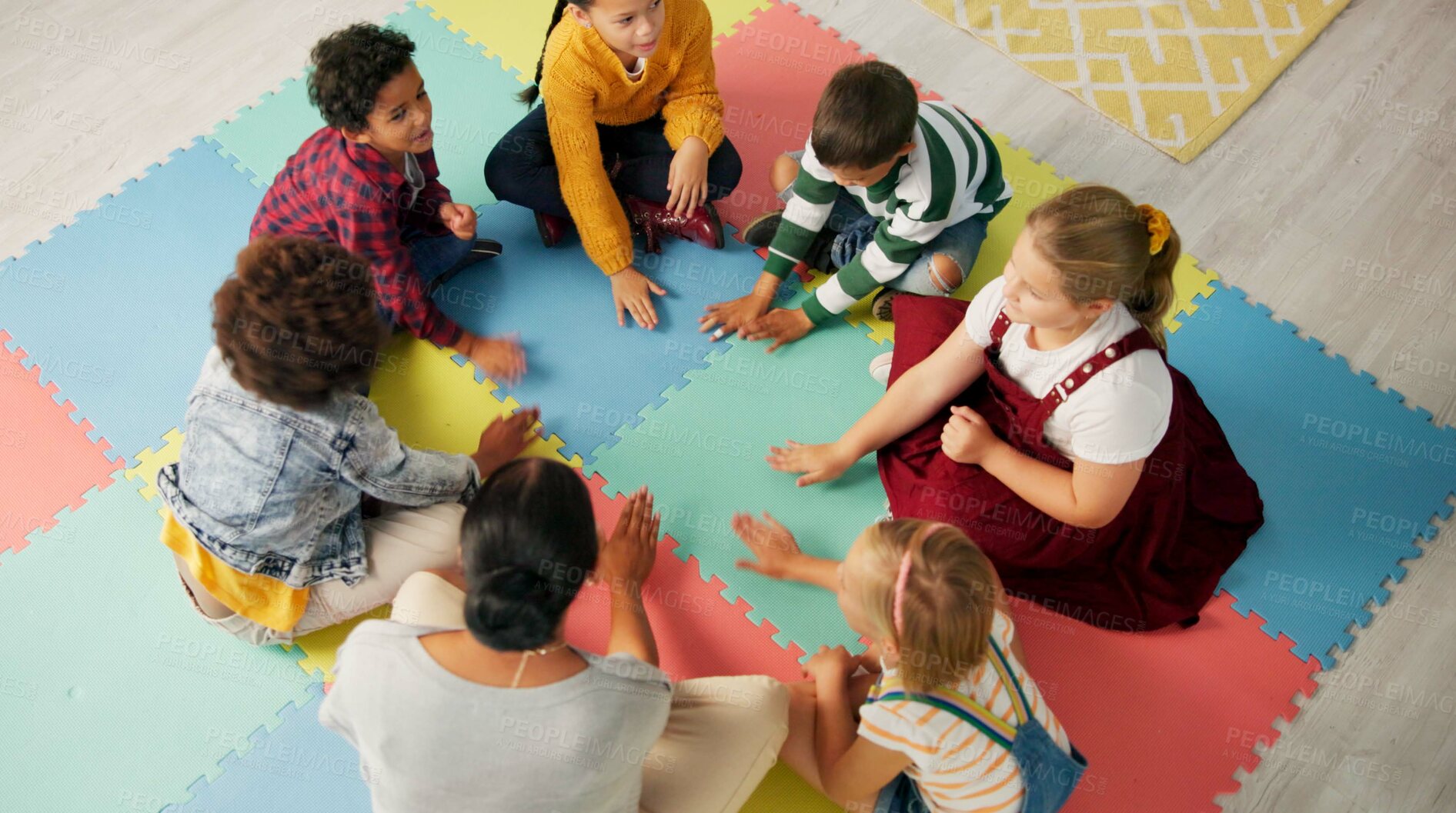 Buy stock photo School, kids and teacher with game in circle for child development, activity and growth. High angle, hands and playful student on mat in kindergarten for sensory learning, creative skill or education