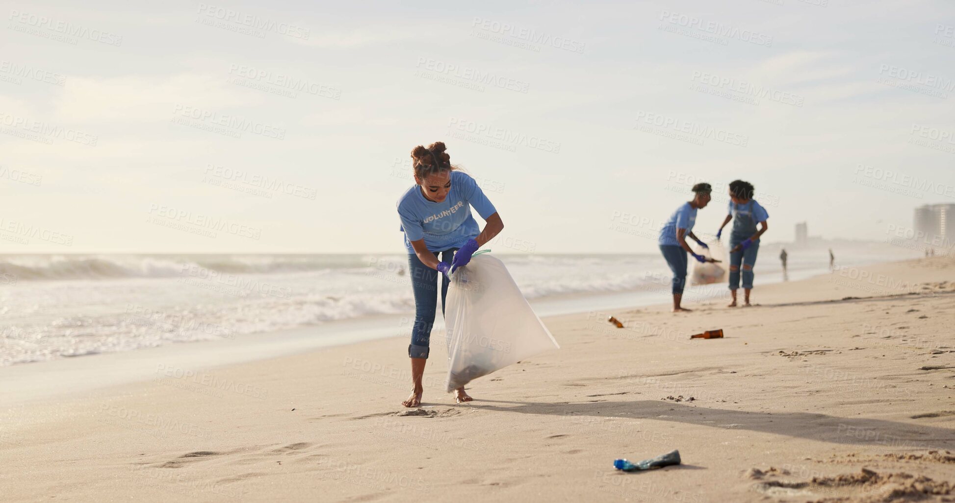 Buy stock photo Cleaning, volunteer and team of women, beach and gloves for recycling, waste and outdoor in nature. Collaboration, group and female people, ready and helping environment, cleaning and litter in sea