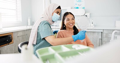 Buy stock photo Happy woman, dentist and patient with mirror for treatment, dental care or teeth cleaning at clinic. Young female person, orthodontist and customer with big smile for oral, gum or tooth whitening