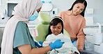 Child, pediatric dentist or education of brushing teeth in surgery or family friendly demonstration of tooth hygiene. Girl, parent or orthodontist with dental model to brush or lesson on mouth care