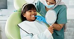 Dentist, woman and child with mirror for dental health, results and teeth cleaning service with medical advice or support. Orthodontist or doctor talking to kid or girl of tooth, procedure and mouth