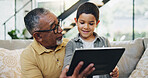 Tablet, sofa and child with grandfather in living room for choosing movie, video or film together. Happy, bonding and boy kid watching online show on digital technology with senior man at home.