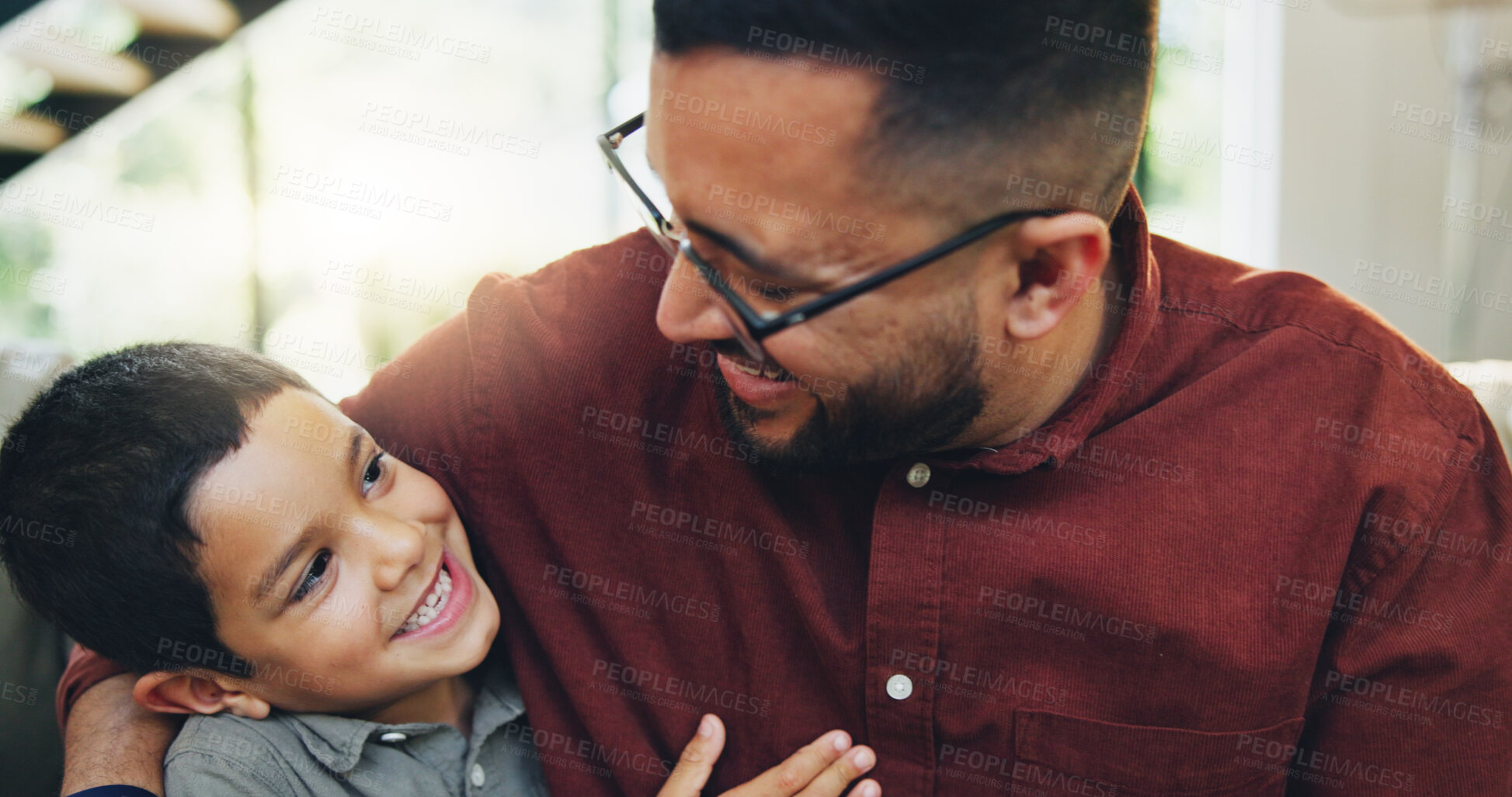 Buy stock photo Smile, hug and child with dad on sofa in home relaxing together for fathers day celebration. Happy, love and boy kid embracing with man for care, bonding and family time in living room at house.