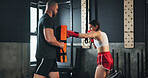 Woman, coach and gloves for training as athlete in fitness center for challenge in sports or wellness. People, workout and strong with health, ready for performance in mma, boxing match or fight