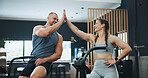 High five, fitness bike or people in gym for training, workout or cardiovascular endurance. Health, happy friends or celebration with hand gesture on bicycle for exercise, calorie burning or teamwork