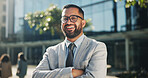 Businessman, portrait and arms crossed in outdoor on break at office building as account manager in firm. Career person, professional and confidence with excited for promotion at company in England