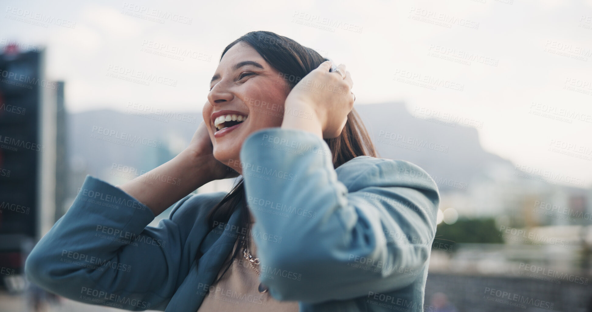 Buy stock photo Happy person, headphones and laughing in city with music on app for online streaming in outdoor for celebration. Career woman, technology and cheerful for promotion, achievement or success in England