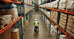 Warehouse, shipping and man walking in a distribution, freight and supply chain company. Worker, contractor and back with stock, factory and export business with employee working with storage