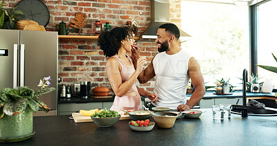 Buy stock photo Happy, couple and feeding with food in kitchen for meal prep, bonding and support in cooking. Vegan, man and woman with eating to taste at home for healthy diet, nutrition and love in marriage