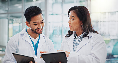 Buy stock photo Asian doctors, man and woman with tablet, smile or check results for medical services at hospital. People, happy and digital touchscreen in clinical study, review and feedback at clinic in Indonesia