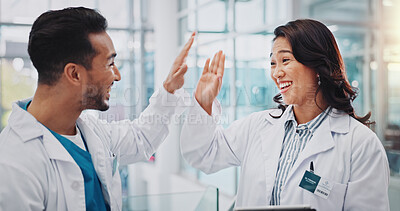 Buy stock photo Doctors, man and woman with high five for teamwork, success and goals for healthcare services in clinic. People, partnership and celebration with cheers for achievement, results and smile in hospital