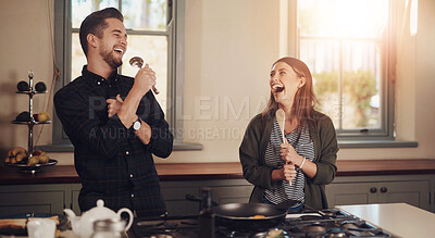 Buy stock photo Couple, singing and cooking in home with laughing, funny joke and celebration on wedding anniversary. Kitchen, love and happy people together with fun, bonding and care with breakfast and commitment