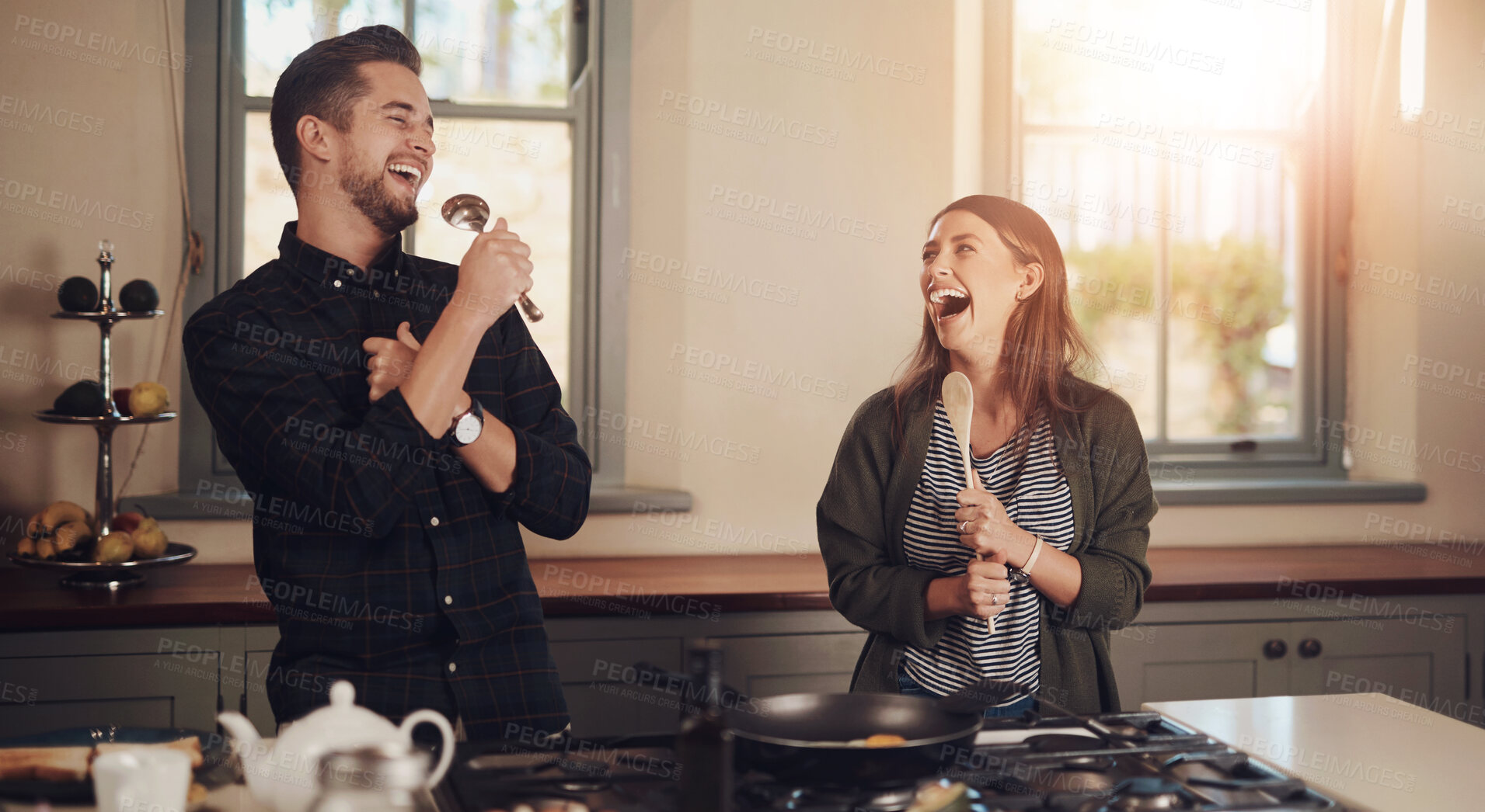 Buy stock photo Couple, singing and cooking in home with laughing, funny joke and celebration on wedding anniversary. Kitchen, love and happy people together with fun, bonding and care with breakfast and commitment