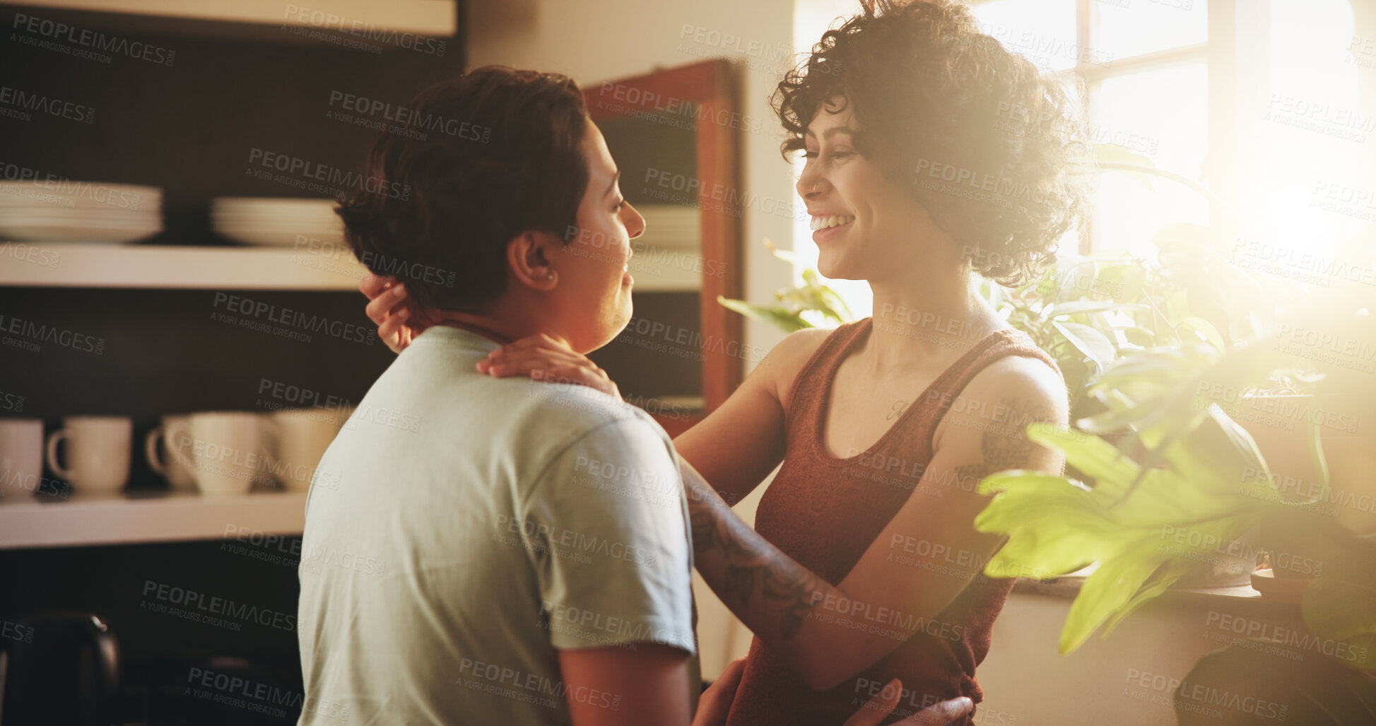 Buy stock photo Couple, lesbian women and hug with smile in kitchen, sunshine or bonding with connection in morning at house. People, partner and happy for embrace with care, love and lgbtq relationship in apartment