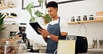 Man, cafe and barista with order on tablet at counter for sale, ecommerce and service at shop. Male person, small business and waiter with technology for website, networking or online menu update