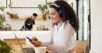 Laptop, cafe and woman with remote work, phone text and headphones for social media blog post. Typing, music and website update of a web designer working at a restaurant and coffee shop with drink