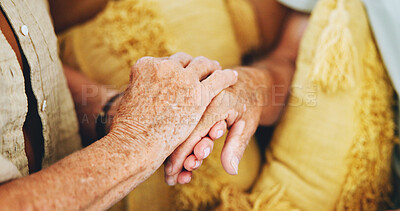 Buy stock photo Senior couple, sofa and holding hands for love, care or support with health, wellness or grief at home. Elderly people with empathy, kindness and faith or hope and comfort for news of cancer on couch