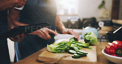 Buy stock photo Hands, tablet and salad recipe in kitchen with help, support and teaching at home for healthy food. People cooking lunch on digital tech for nutrition tips with lettuce, cucumber and green vegetables