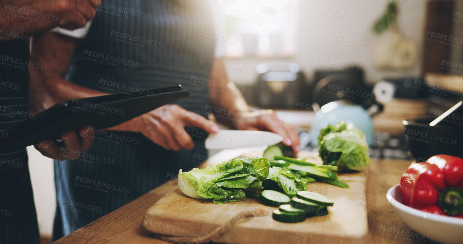 Buy stock photo Hands, tablet and salad recipe in kitchen with help, support and teaching at home for healthy food. People cooking lunch on digital tech for nutrition tips with lettuce, cucumber and green vegetables