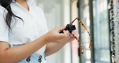 Buy stock photo Hands, glasses and cloth at shop for optometry, vision and wellness for eyesight, cleaning and dirt. Woman, customer and fabric for dust with inspection for eye care, health or style at retail store