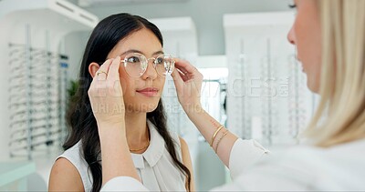 Buy stock photo Vision, ophthalmology and help customer with glasses for eye health, wellness and care. Optometrist, lens and woman fitting frame for choice of spectacles or eyesight correction of client at store