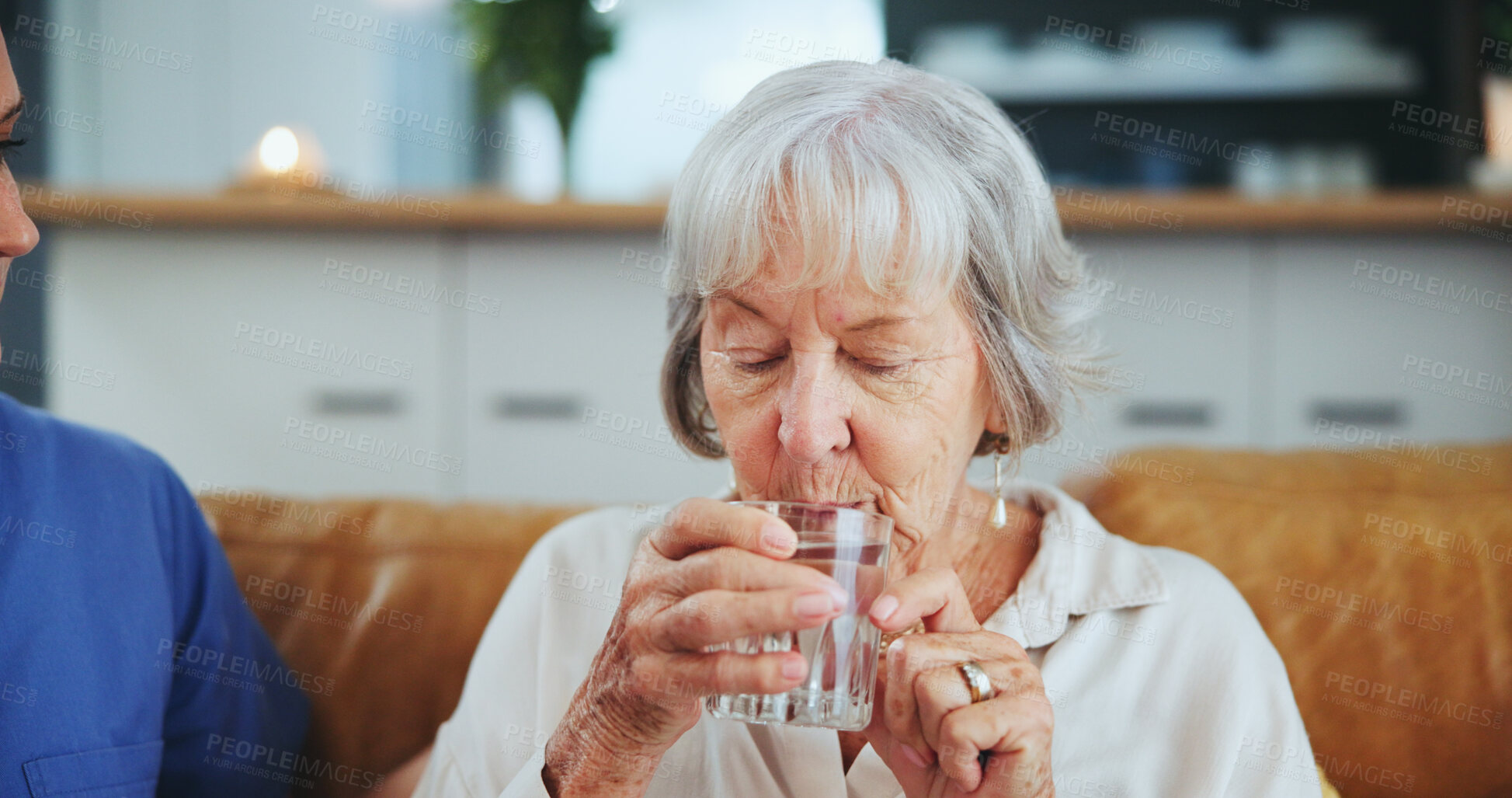 Buy stock photo Senior woman, nurse and glass for drinking water on sofa with thirst, medicine and wellness in living room. People, caregiver and elderly patient with health, detox and gut health on couch in house