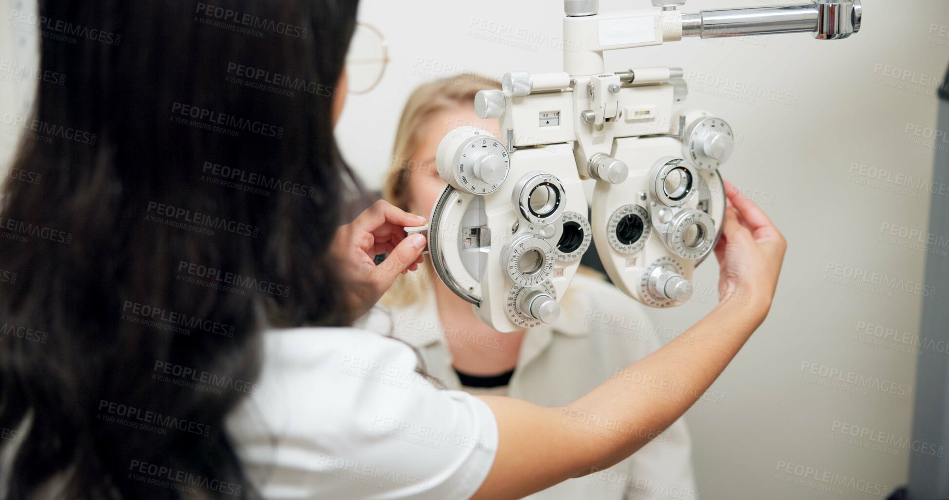 Buy stock photo Doctor, optometry and woman on phoropter for eye care, consultation or health exam in clinic. Ophthalmologist, test or patient on lens machine tool for vision check, wellness and eyesight correction