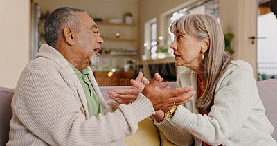 Buy stock photo Elderly couple, talking and arguing in lounge, couch and discussion in retirement, weekend and upset in house. Angry, old man and woman in living room, fighting and people in apartment and marriage