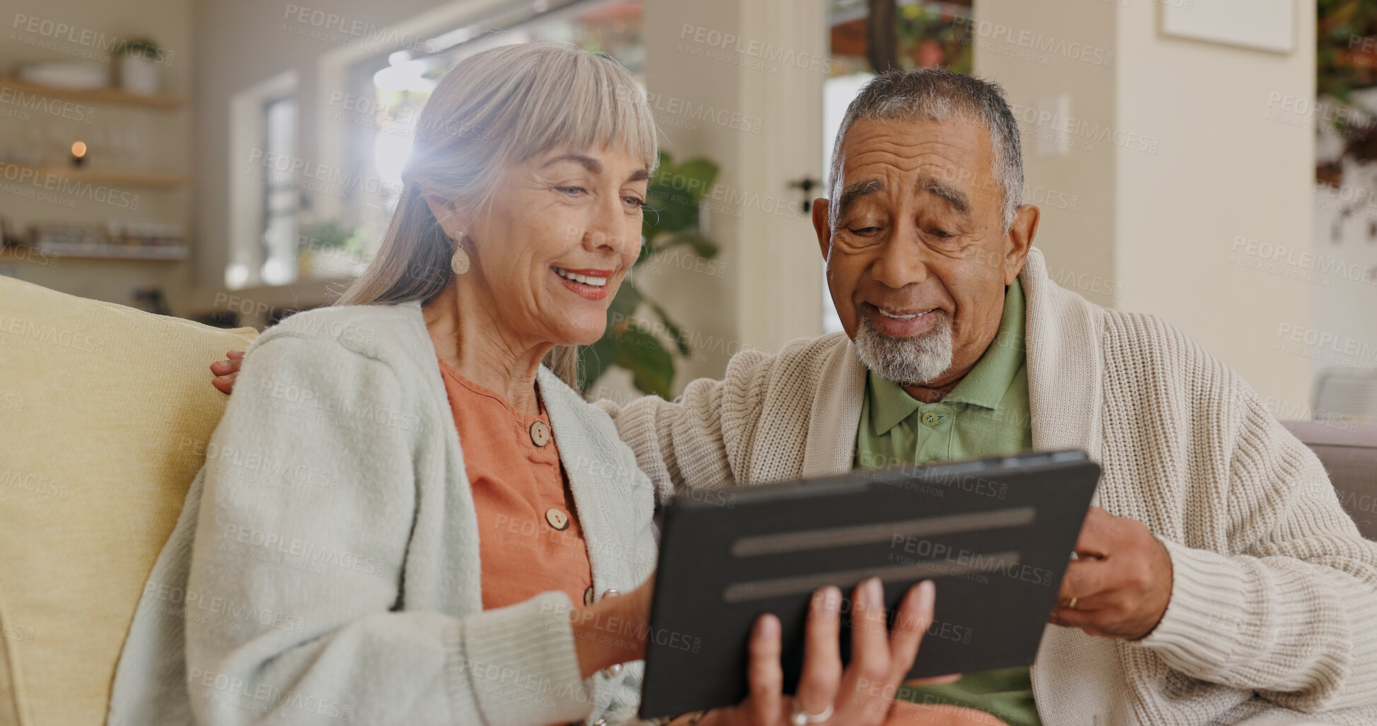 Buy stock photo Senior couple, home and tablet for internet research with retirement and streaming movie. Interracial marriage, old man and woman with digital tech in kitchen for video call app and virtual chat
